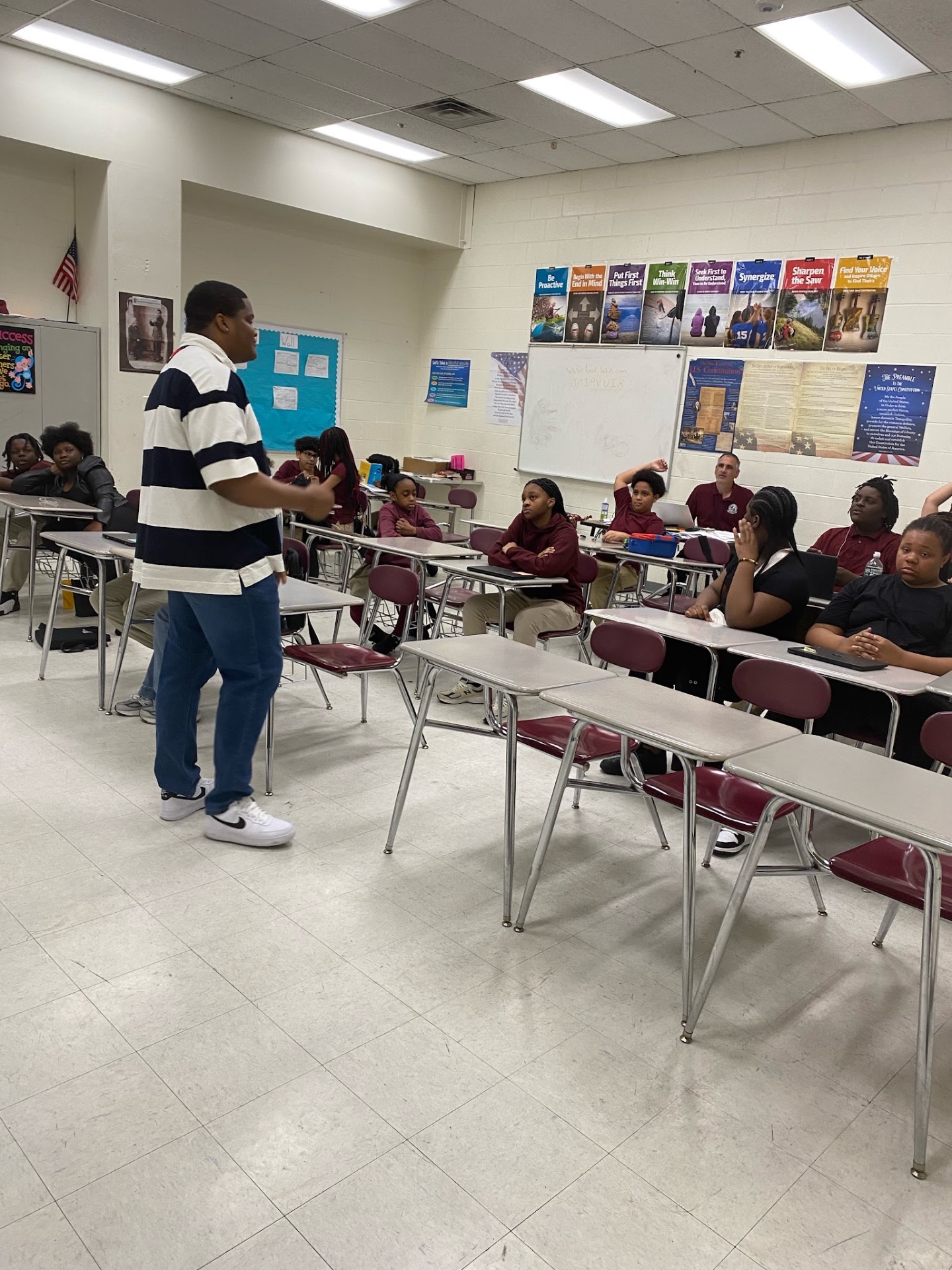 Classroom session with students raising hands